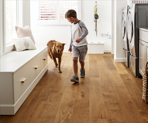 Dog and kid running on hardwood floor