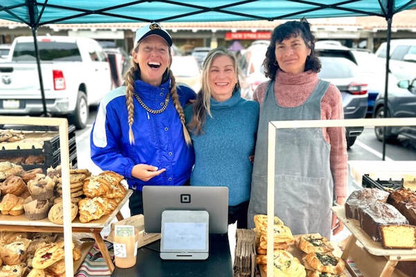 Farmers market stand run by women