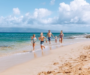 Family running on the beach